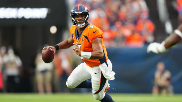 Denver Broncos quarterback Russell Wilson (3) scrambles with the ball in the third quarter against the Las Vegas Raiders at Empower Field at Mile High.